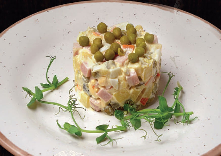 Russian salad with boiled vegetables and ham or chicken