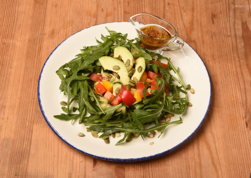 Fresh vegetable salad with avocado and spicy dressing